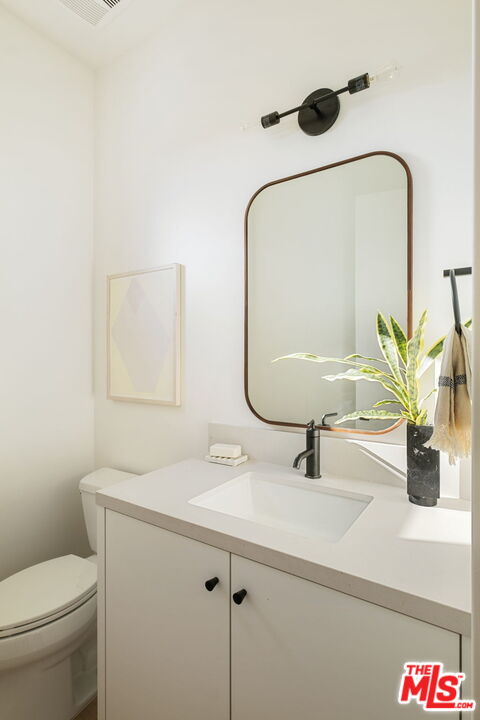 762 North Arthur Road Los Angeles, CA 90029 - Photo 15 of 30 a bathroom with a sink a toilet and mirror