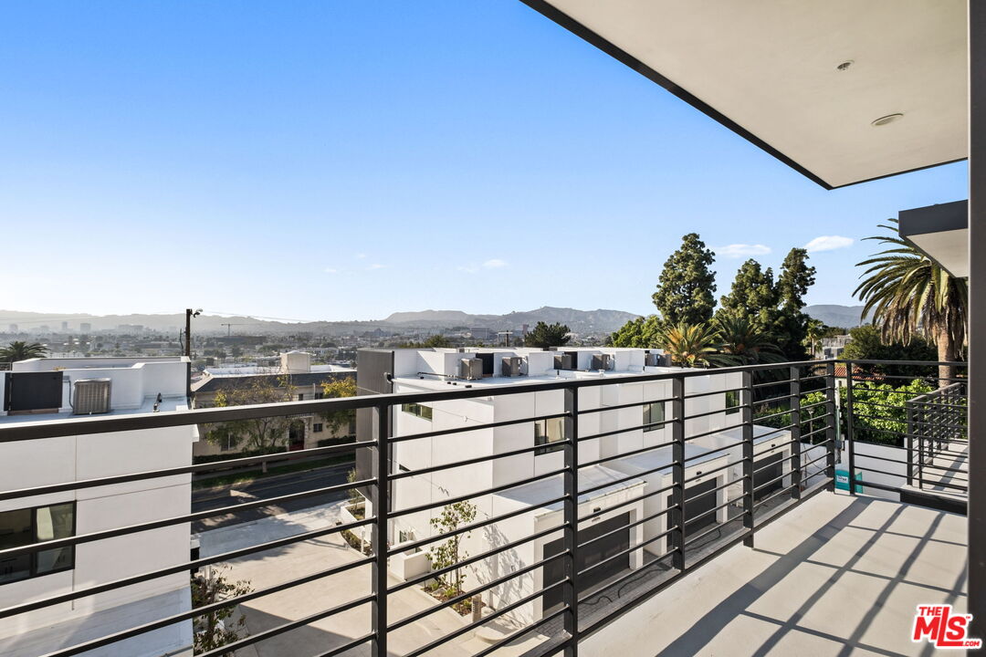 762 North Arthur Road Los Angeles, CA 90029 - Photo 19 of 30 a view of a balcony with chairs and wooden floor