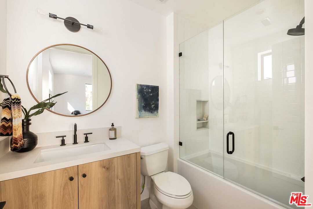 762 North Arthur Road Los Angeles, CA 90029 - Photo 27 of 30 a bathroom with a sink a toilet and a mirror