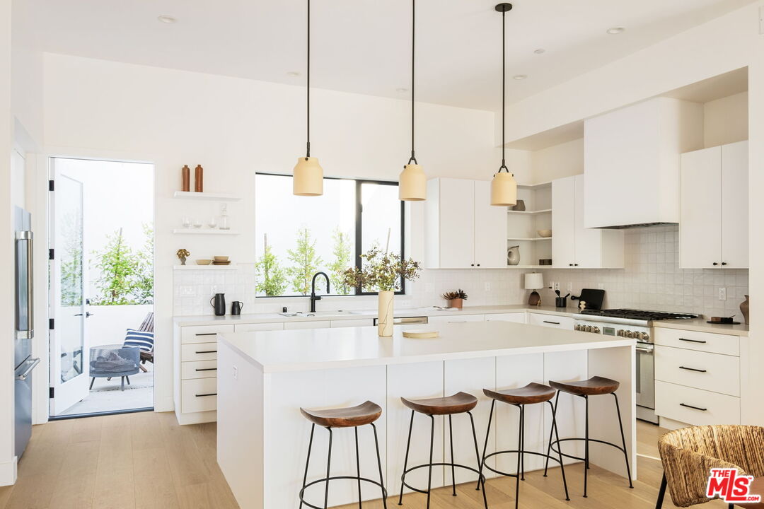 762 North Arthur Road Los Angeles, CA 90029 - Photo 3 of 30 a kitchen with stainless steel appliances kitchen island granite countertop a sink a stove and a cabinets