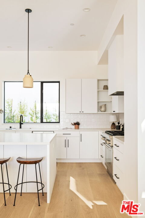 762 North Arthur Road Los Angeles, CA 90029 - Photo 5 of 30 a kitchen with stainless steel appliances a stove a sink a center island and cabinets