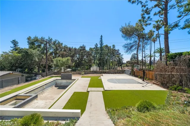 swimming pool view with a sitting space