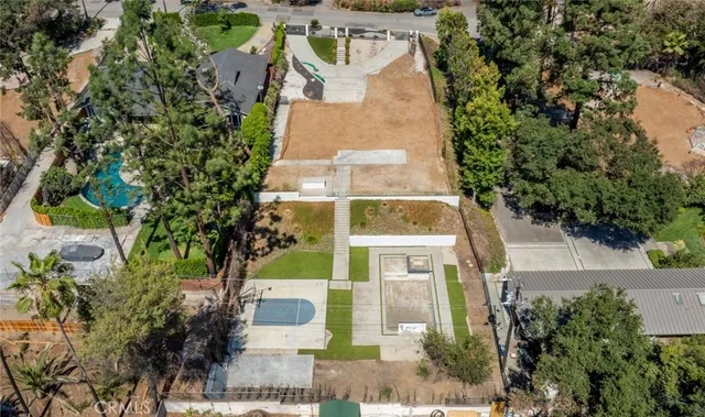 an aerial view of a house with a yard basket ball court and outdoor seating