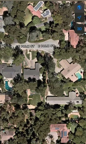 an aerial view of residential houses with outdoor space and swimming pool