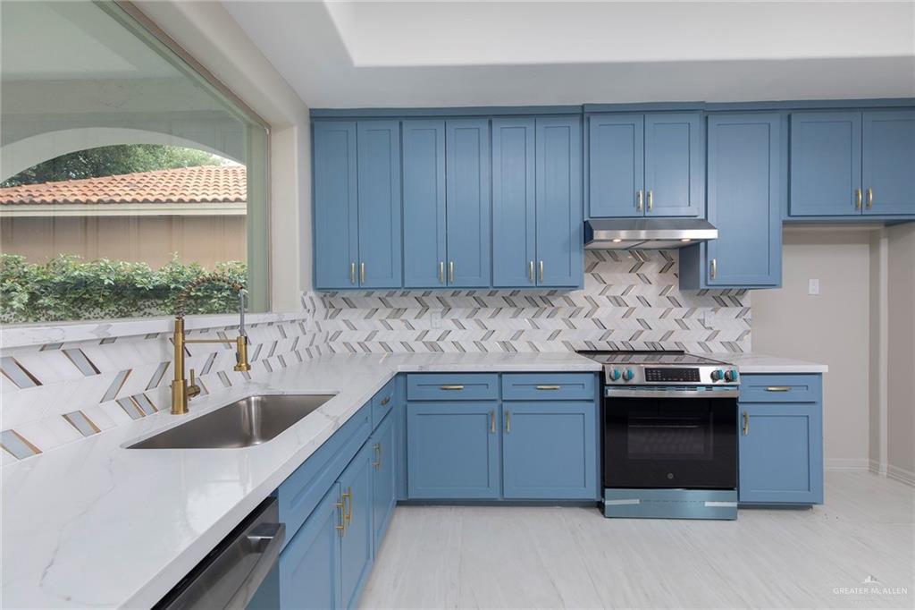 2216 South 45th Street McAllen, TX 78503 - Photo 12 of 40 a kitchen with stainless steel appliances granite countertop a sink and a stove