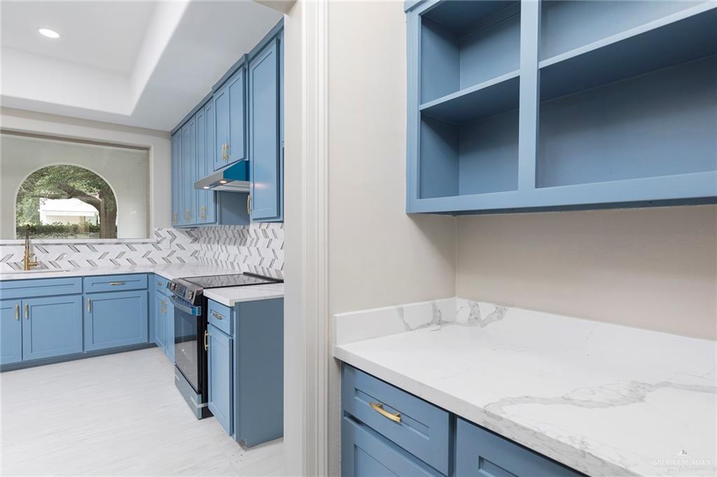 2216 South 45th Street McAllen, TX 78503 - Photo 14 of 40 a kitchen with a sink and cabinets