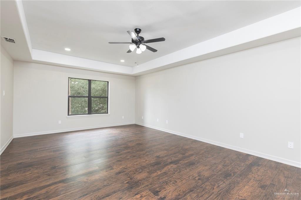 2216 South 45th Street McAllen, TX 78503 - Photo 18 of 40 an empty room with wooden floor fan and windows