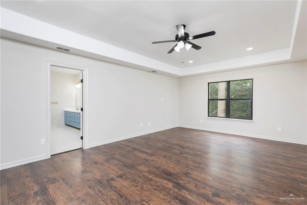 2216 South 45th Street McAllen, TX 78503 - Photo 19 of 40 a view of an empty room with wooden floor and a window