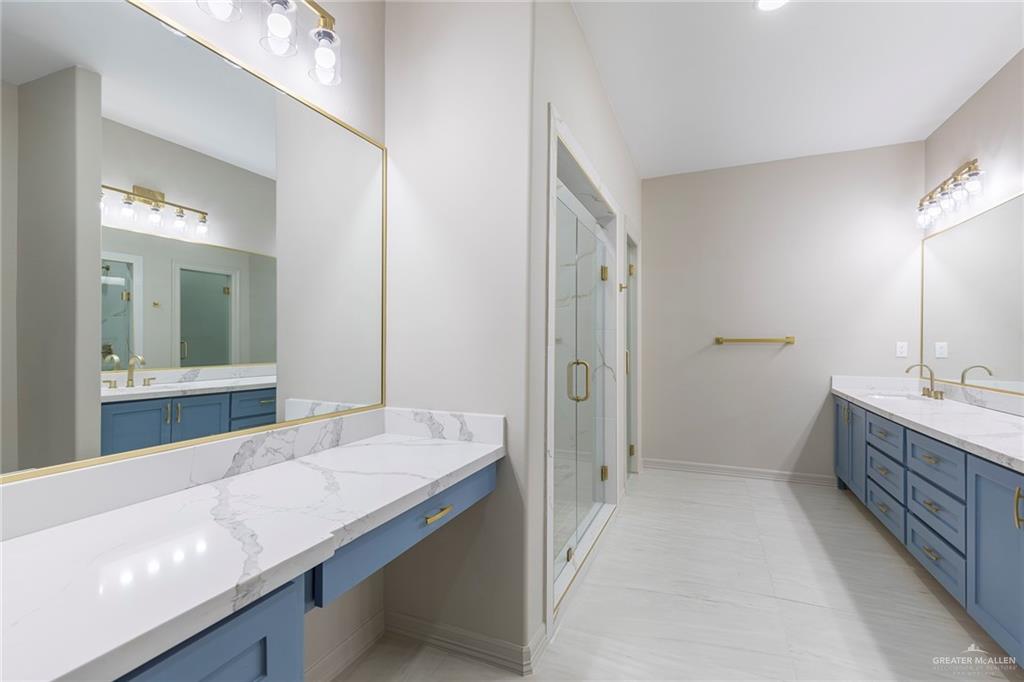 2216 South 45th Street McAllen, TX 78503 - Photo 20 of 40 a bathroom with a granite countertop double vanity sink a mirror and a bathtub