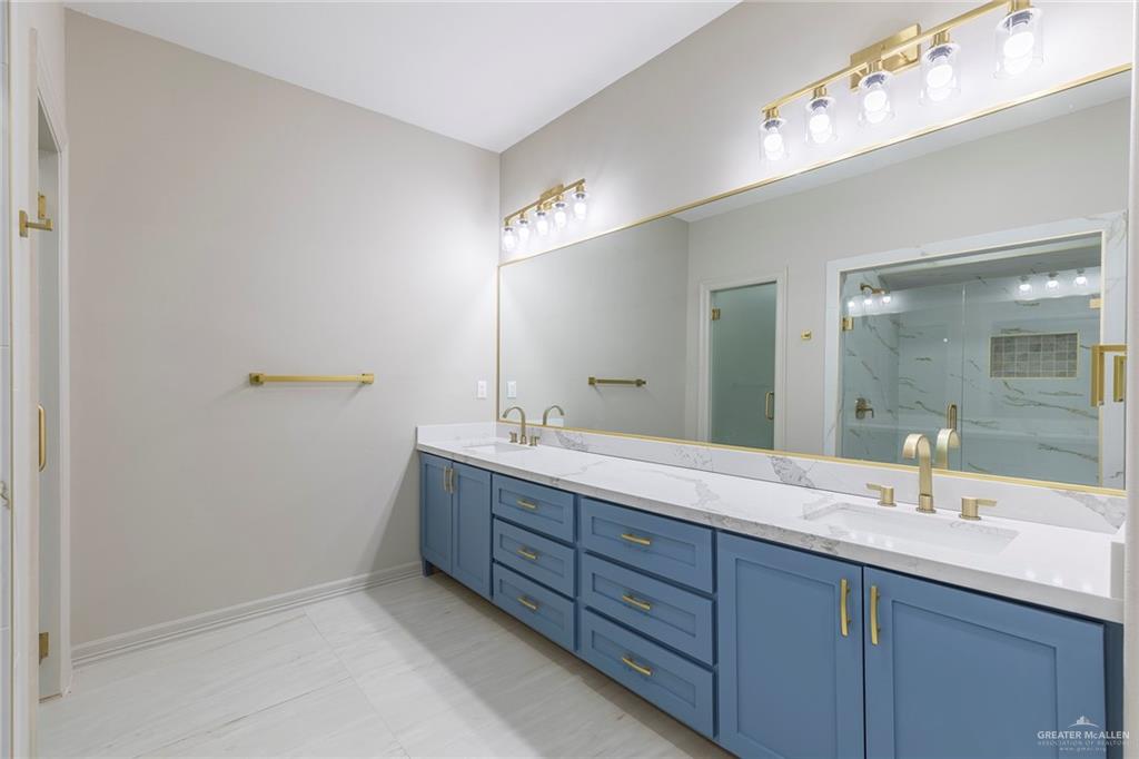 2216 South 45th Street McAllen, TX 78503 - Photo 21 of 40 a bathroom with a double vanity sink and mirror