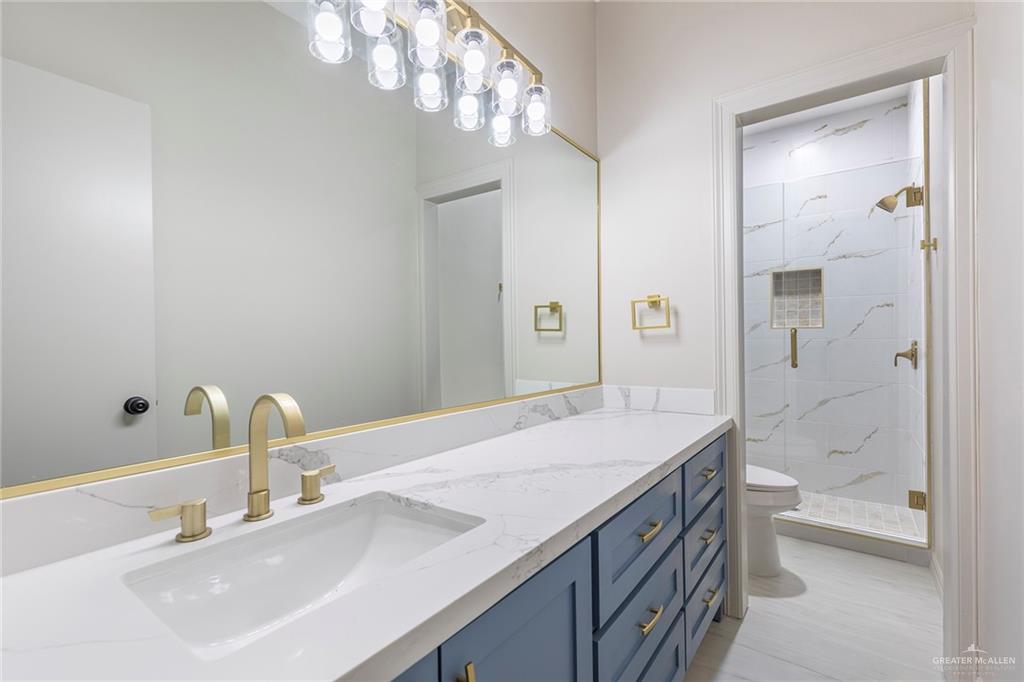 2216 South 45th Street McAllen, TX 78503 - Photo 29 of 40 a bathroom with a sink a toilet and shower