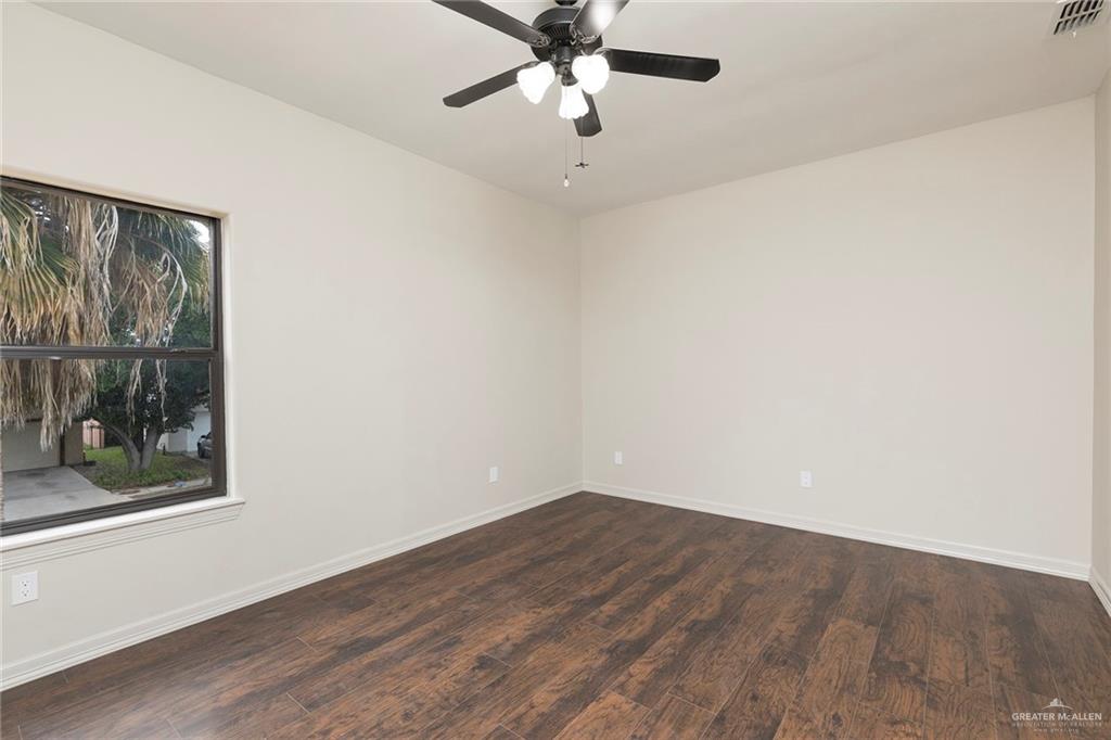 2216 South 45th Street McAllen, TX 78503 - Photo 30 of 40 an empty room with a window and a ceiling fan