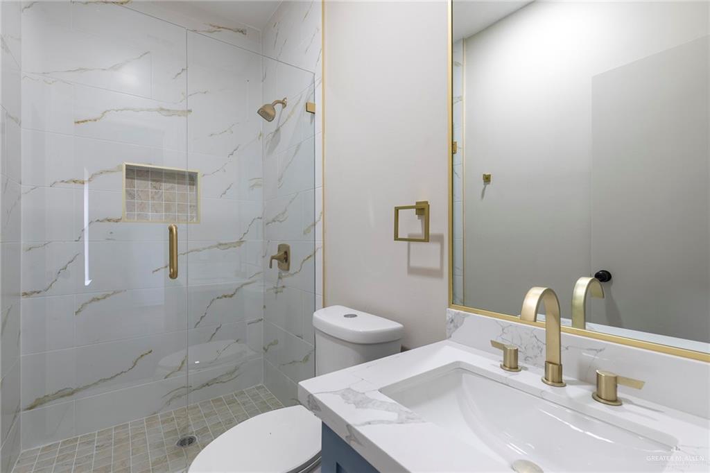 2216 South 45th Street McAllen, TX 78503 - Photo 31 of 40 a bathroom with a sink toilet and shower