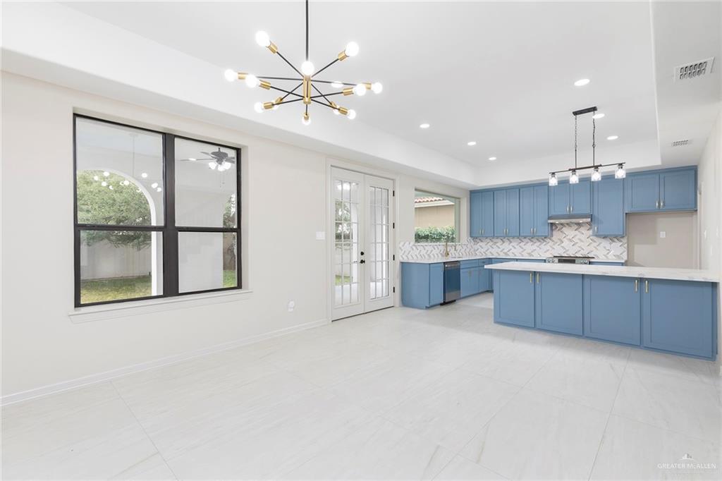 2216 South 45th Street McAllen, TX 78503 - Photo 9 of 40 a large kitchen with a large window and stainless steel appliances