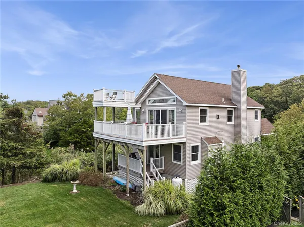 a aerial view of a house next to a yard