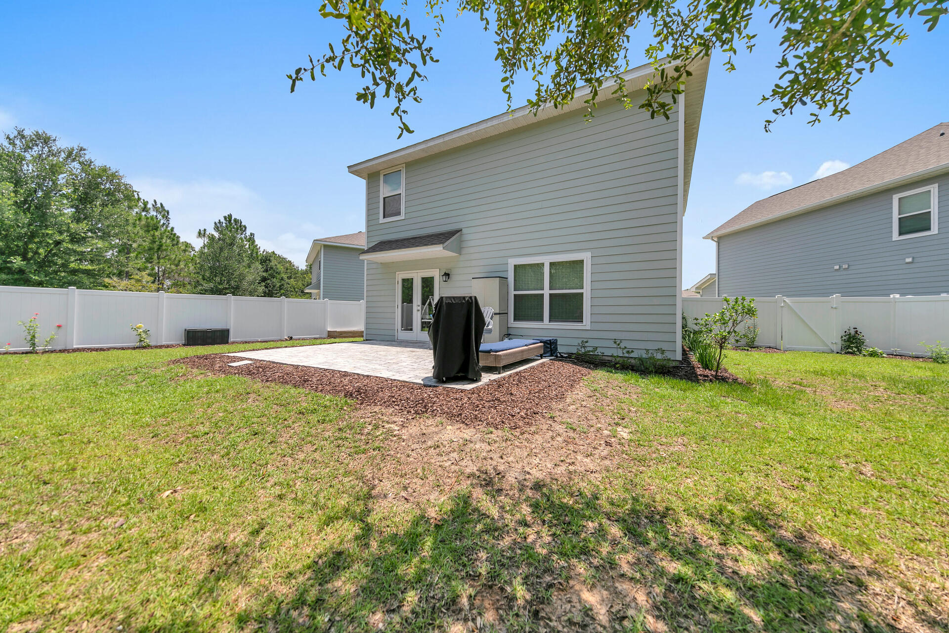 148 Stonegate Circle Santa Rosa Beach, FL 32459 - Photo 27 of 28 a view of a house with backyard and a tree