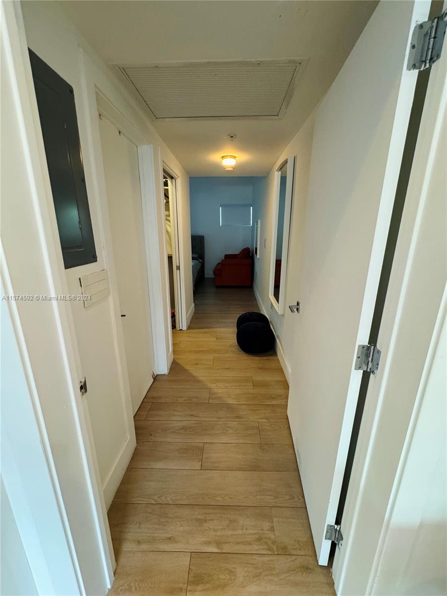 700 16th Street, Unit 108 Miami Beach, FL 33139 - Photo 4 of 10 a view of a hallway with wooden floor and staircase