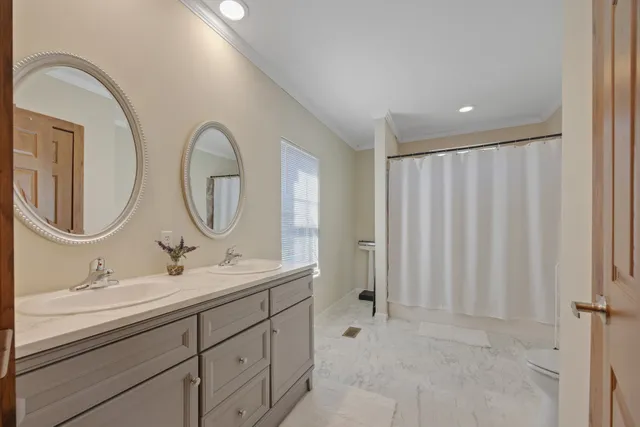 a bathroom with a double vanity sink and a mirror