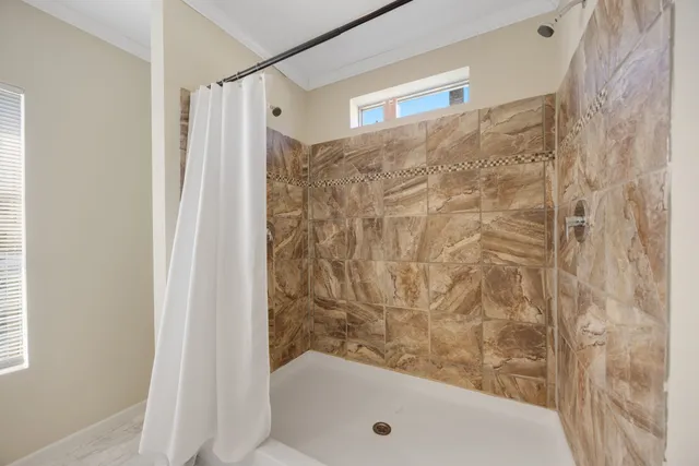 a bathroom with a tub and shower