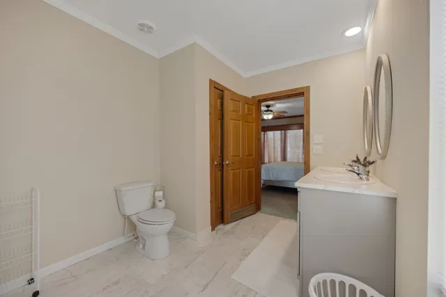 a spacious bathroom with a toilet sink and mirror
