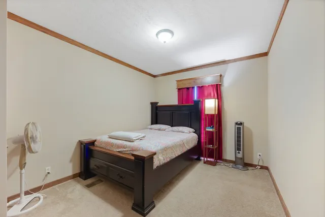 a bedroom with a bed and window