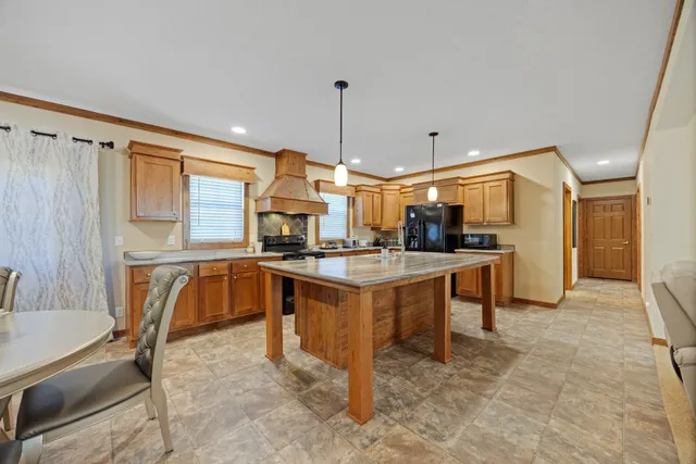 a large kitchen with a table and chairs