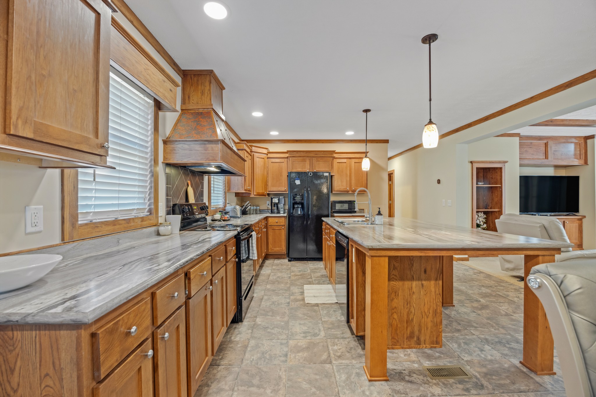 978 Bancroft Road McDonald, TN 37353 - Photo 9 of 29 a kitchen with stainless steel appliances granite countertop a sink and a wooden floor