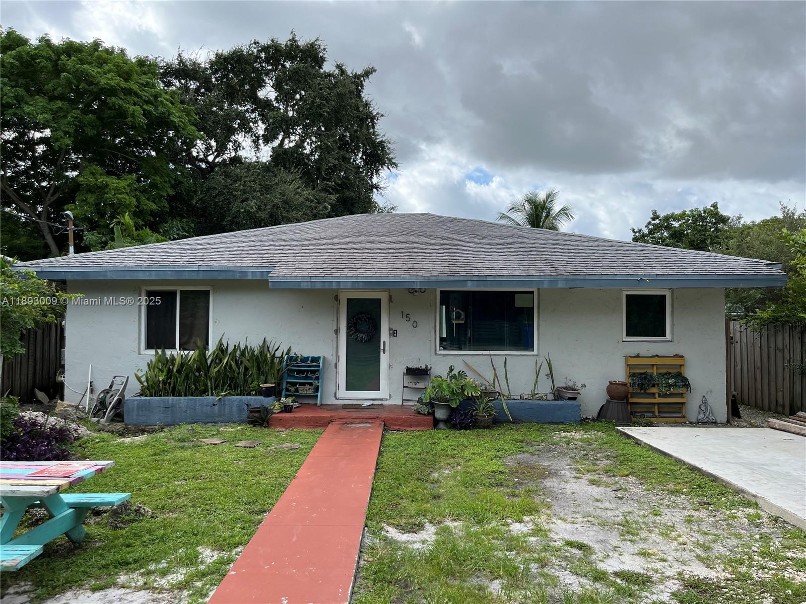 150 Northwest 44th Street Miami, FL 33127 - Photo 2 of 16 a front view of house with a garden