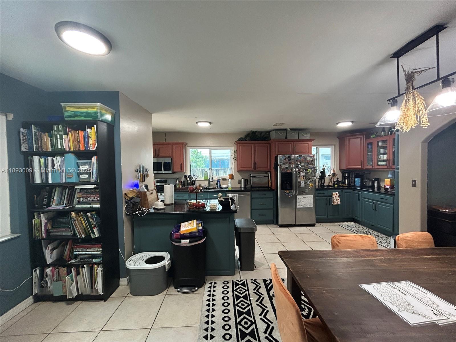 150 Northwest 44th Street Miami, FL 33127 - Photo 3 of 16 a kitchen with a refrigerator and a view of living room