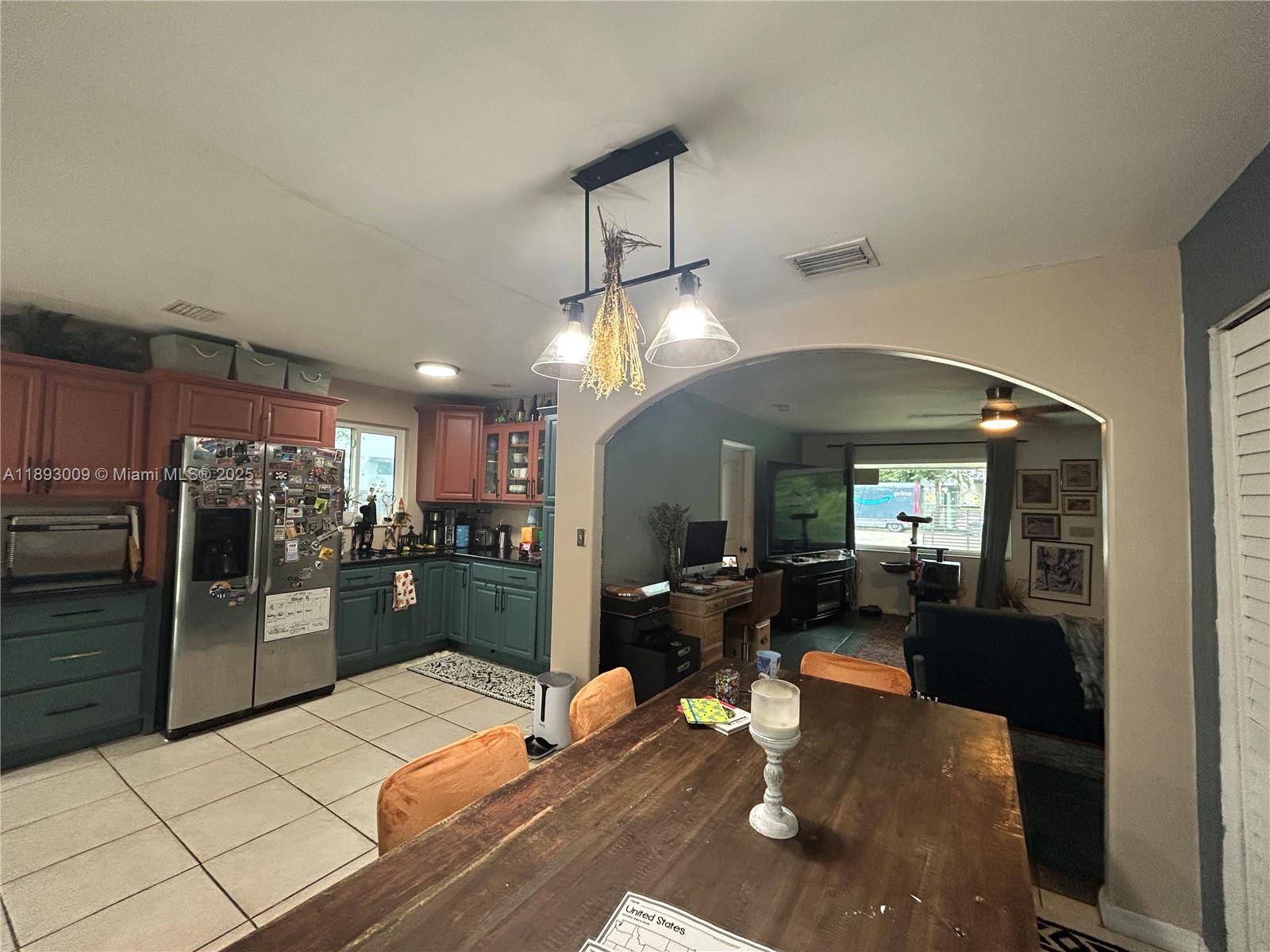 150 Northwest 44th Street Miami, FL 33127 - Photo 4 of 16 a kitchen with stainless steel appliances kitchen island granite countertop a refrigerator a stove and a sink with granite countertops