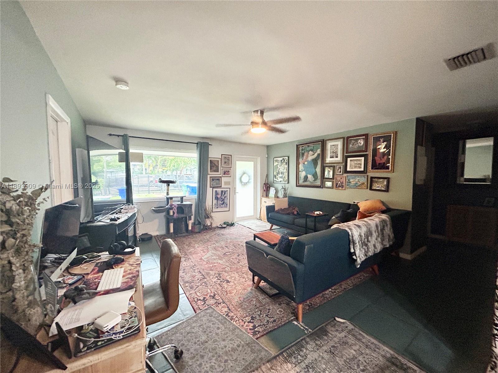 150 Northwest 44th Street Miami, FL 33127 - Photo 5 of 16 a living room with furniture rug and window