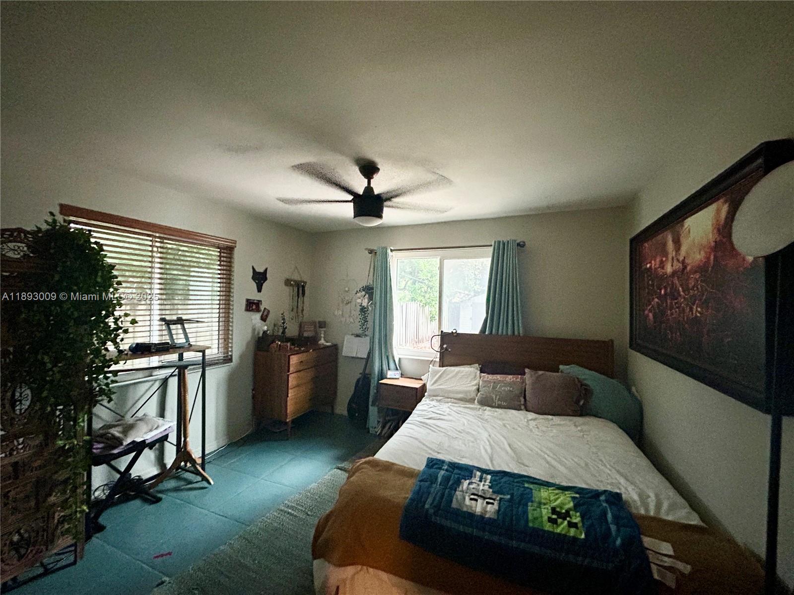 150 Northwest 44th Street Miami, FL 33127 - Photo 7 of 16 a living room with furniture and a flat screen tv