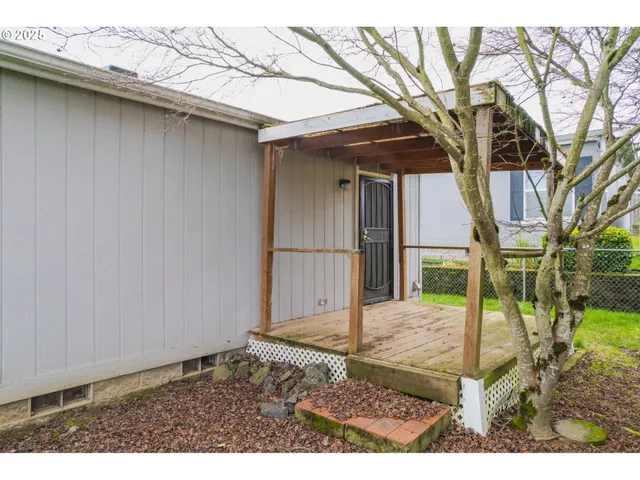 a backyard of a house with a yard and outdoor seating