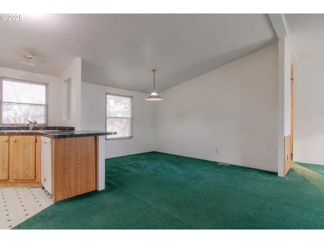 a view of kitchen with granite countertop cabinets