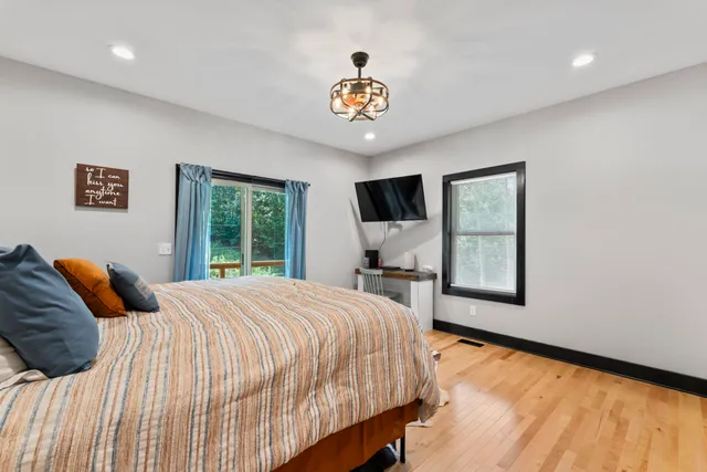 a bedroom with a bed and a large window