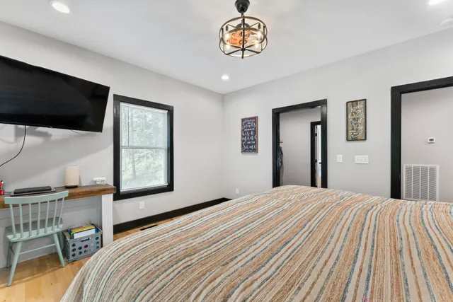 a bedroom with a bed and a flat screen tv