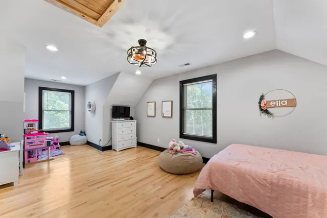 a bedroom with furniture and a wooden floor