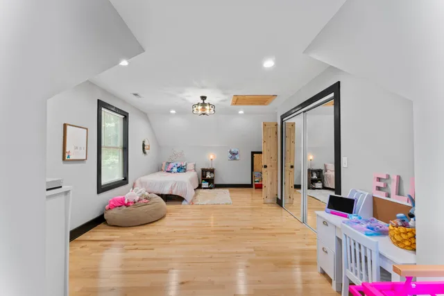 a bedroom with furniture and a large mirror