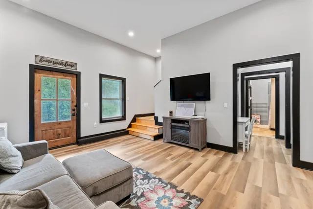 a bedroom with furniture and a flat screen tv