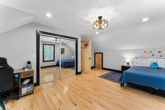 a bedroom with a bed and a chandelier