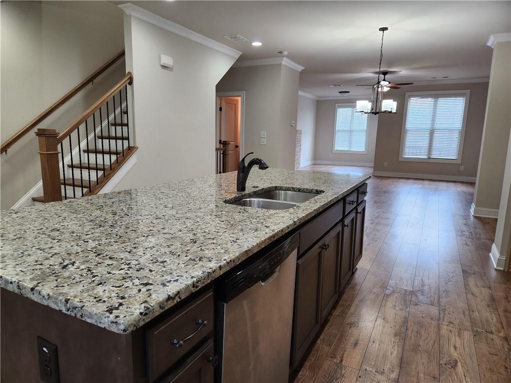 1323 Faircrest Way Suwanee, GA 30024 - Photo 5 of 16 a kitchen with kitchen island granite countertop a wooden floors