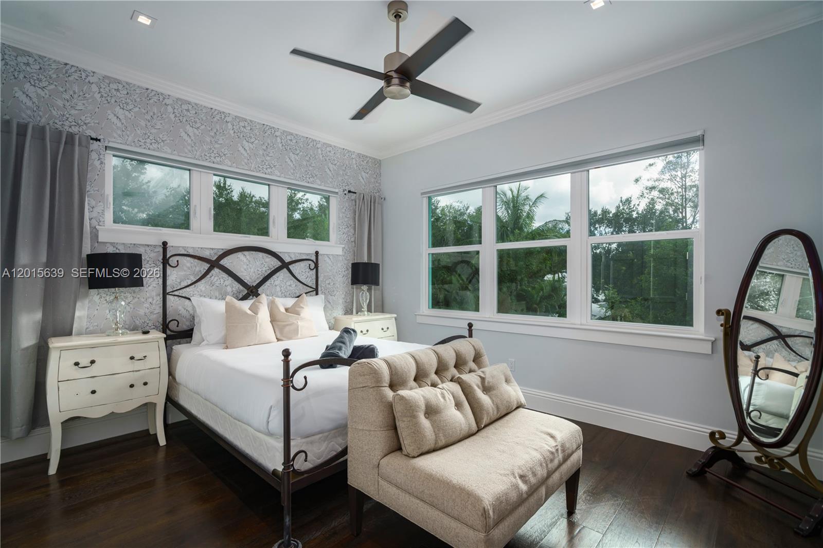 545 Southwest Indianola Street Stuart, FL 34994 - Photo 21 of 64 a bedroom with bed and a large window