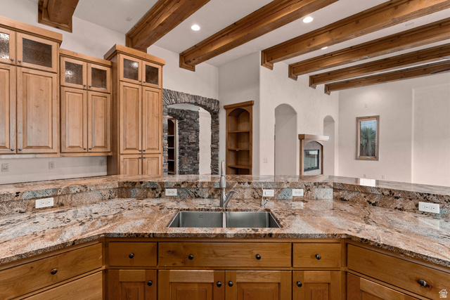 2464 East Granite Way St. George, UT 84790 - Photo 50 of 106 Kitchen with light stone countertops, beamed ceiling, recessed lighting, glass fronted cabinets, and built in features
