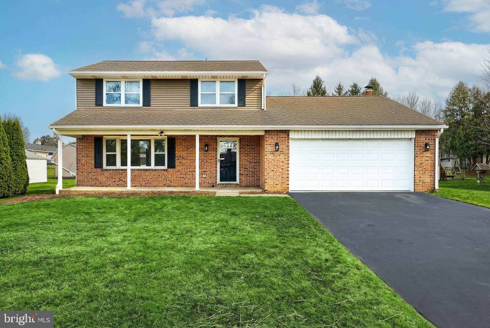2510 Redwood Road Dover, PA 17315 - Photo 3 of 56 a front view of a house with a yard and garage