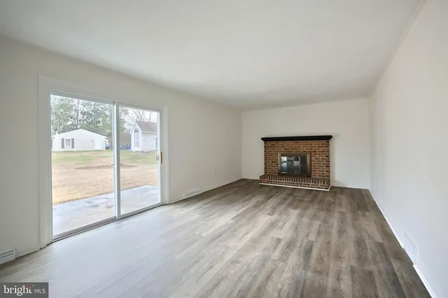 a view of an empty room and wooden floor