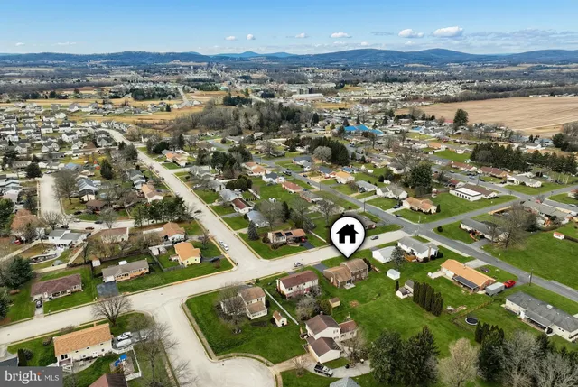 an aerial view of a residential houses with outdoor space