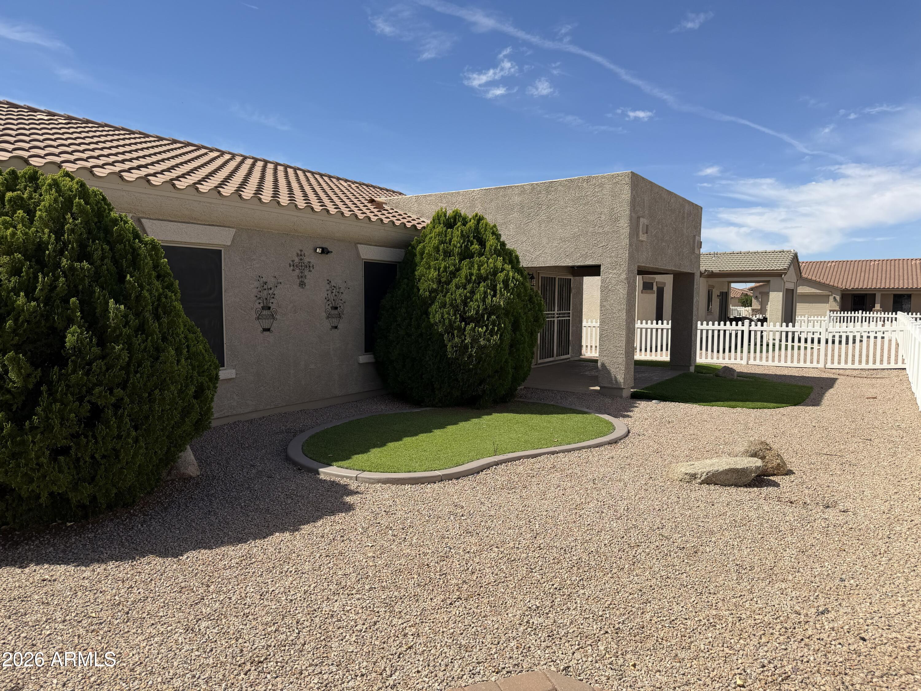 2101 South Meridian Road, Unit 255 Apache Junction, AZ 85120 - Photo 24 of 24 a view of a house with a yard and potted plants