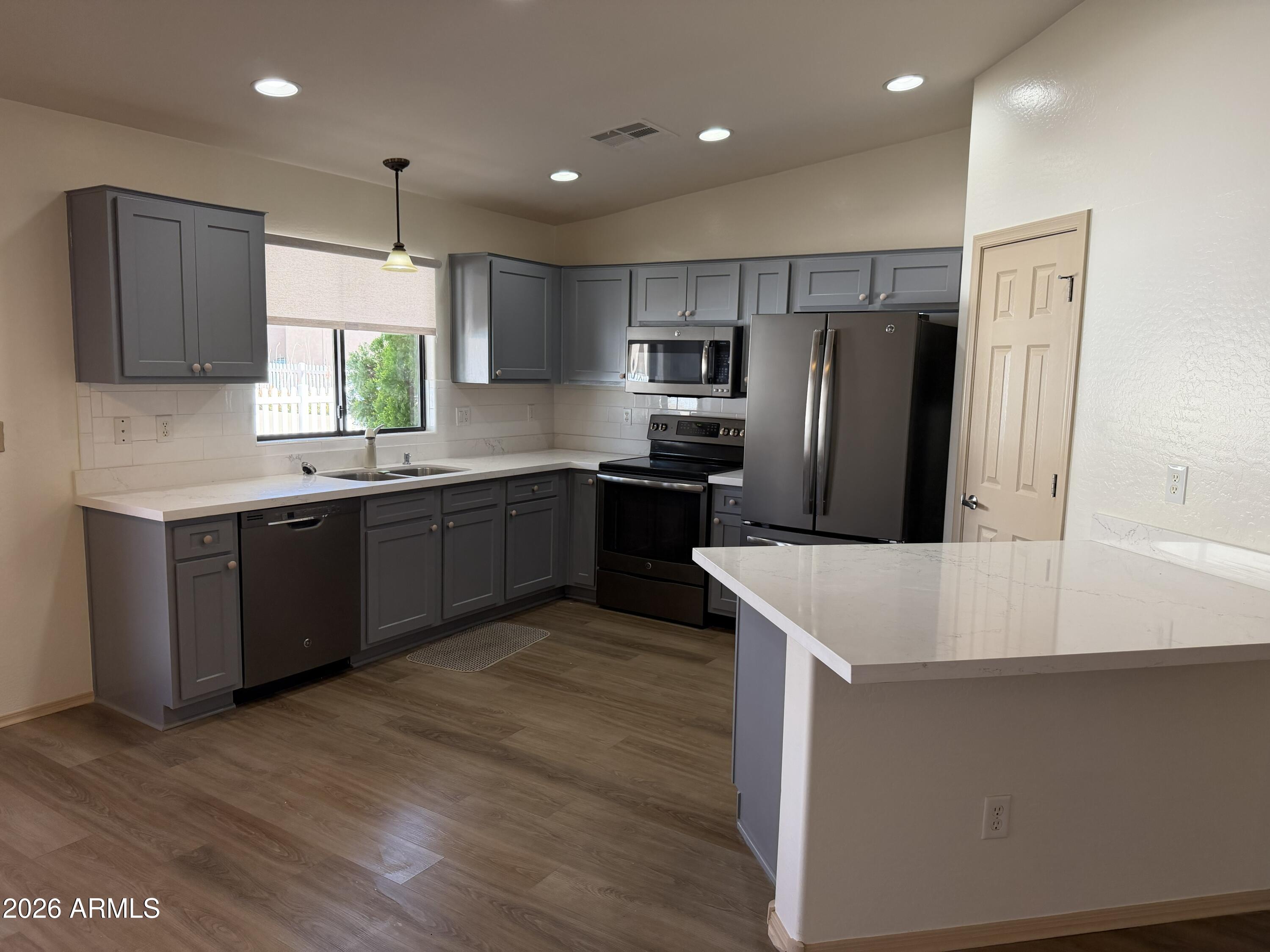 2101 South Meridian Road, Unit 255 Apache Junction, AZ 85120 - Photo 4 of 24 a kitchen with stainless steel appliances a sink a stove a refrigerator and cabinets