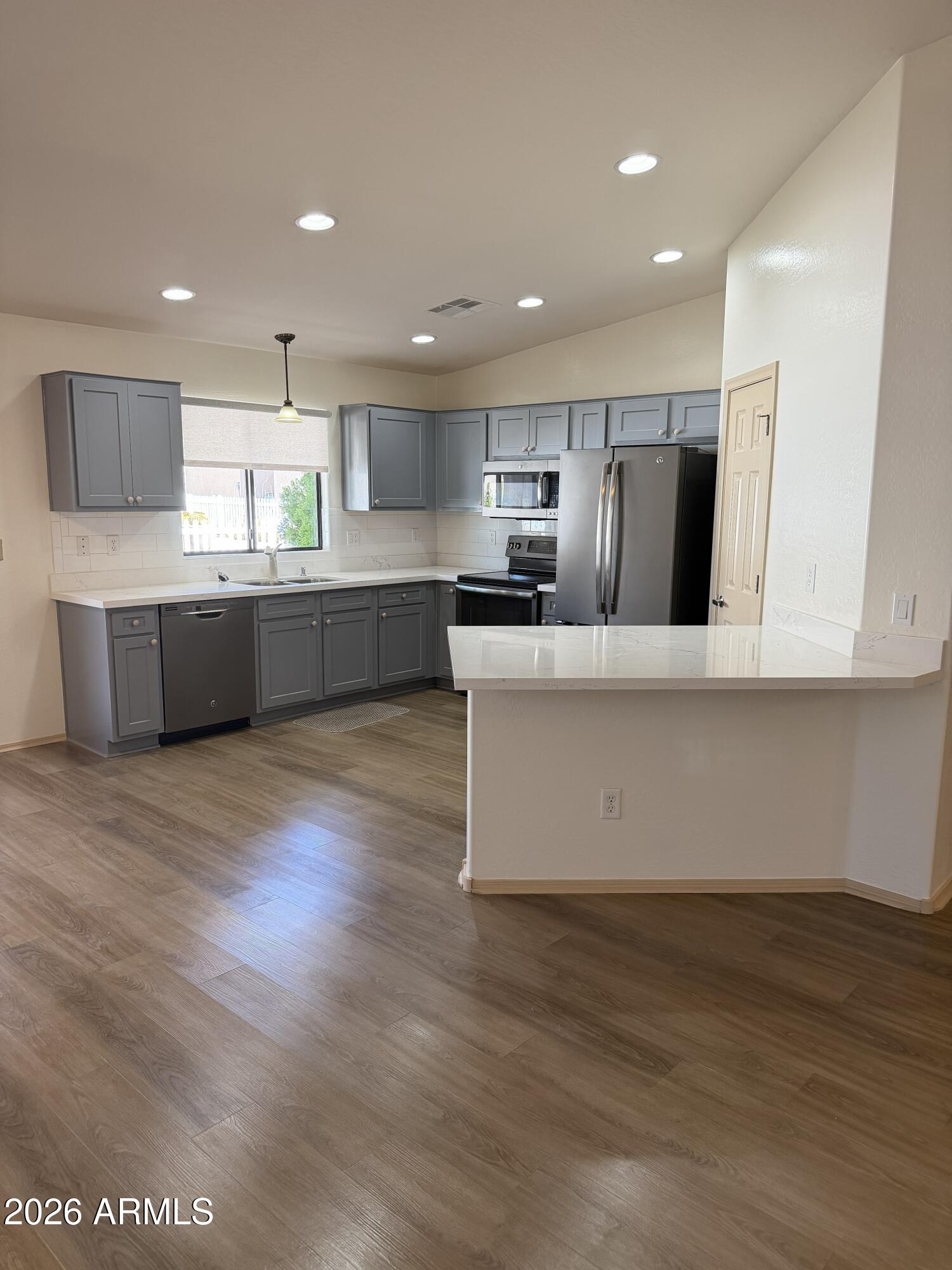 2101 South Meridian Road, Unit 255 Apache Junction, AZ 85120 - Photo 5 of 24 a large kitchen with stainless steel appliances wooden floors and view living room