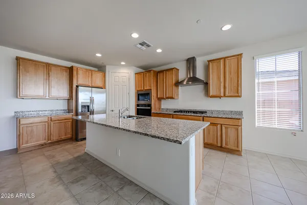 a kitchen with stainless steel appliances granite countertop a sink and cabinets